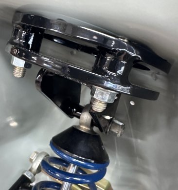 Custom made upper coilover mount fits around the stock coil spring locator ring - no need to remove that from the underside of the shock tower